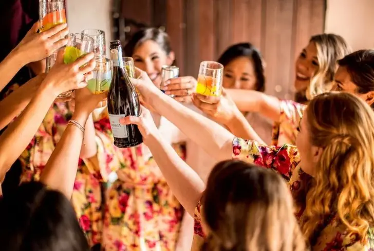 Smiling friends raising glasses for a cheers